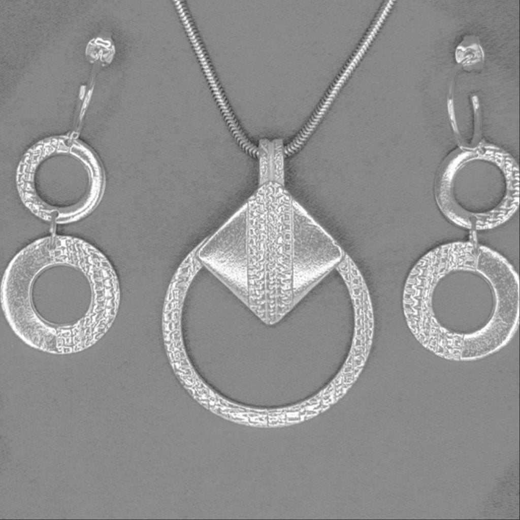 A silver jewelry set featuring a pendant necklace, a matching chain, and a pair of drop earrings with textured circular rings, displayed on a solid gray background.